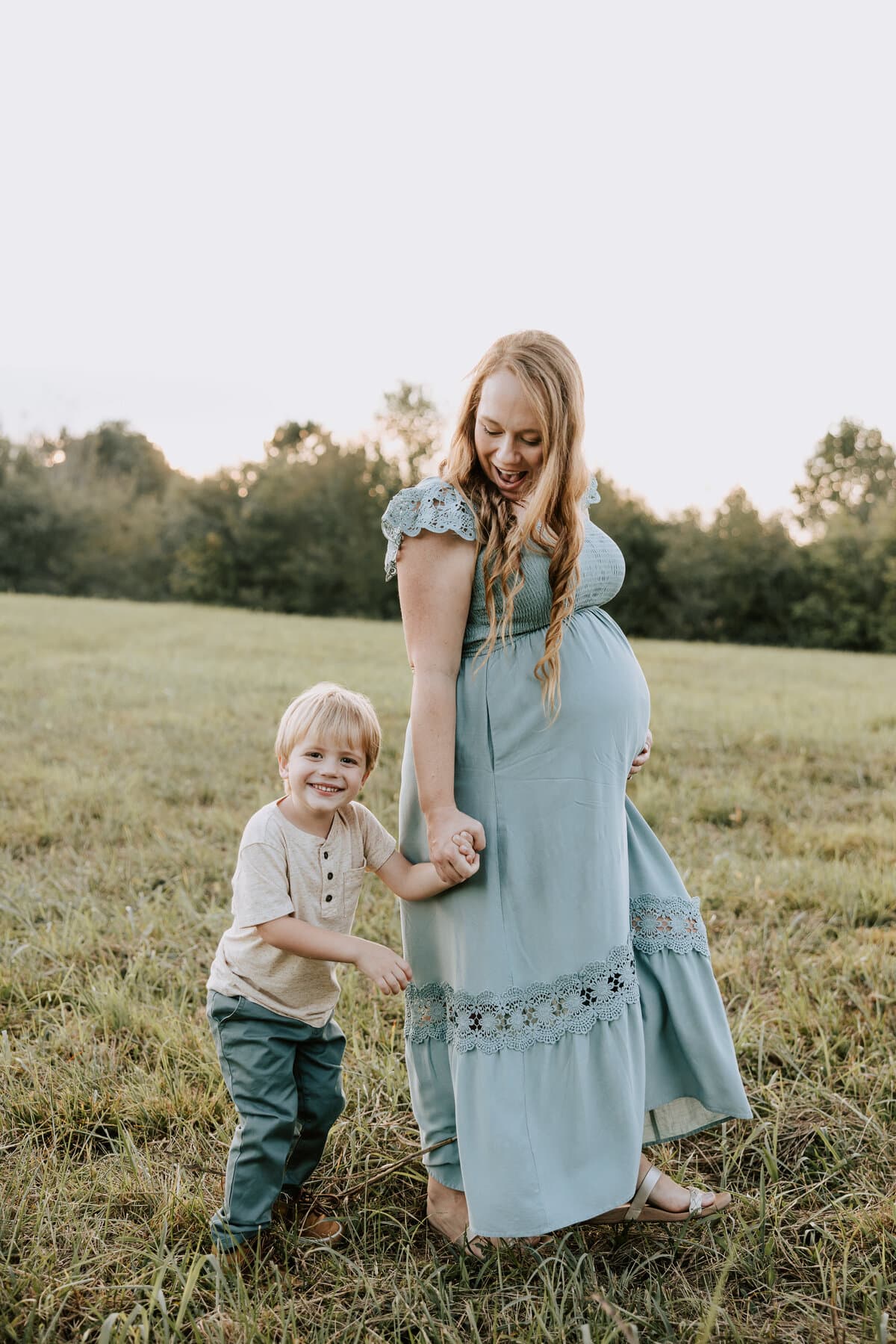 A mother and her son in a field at golden hour